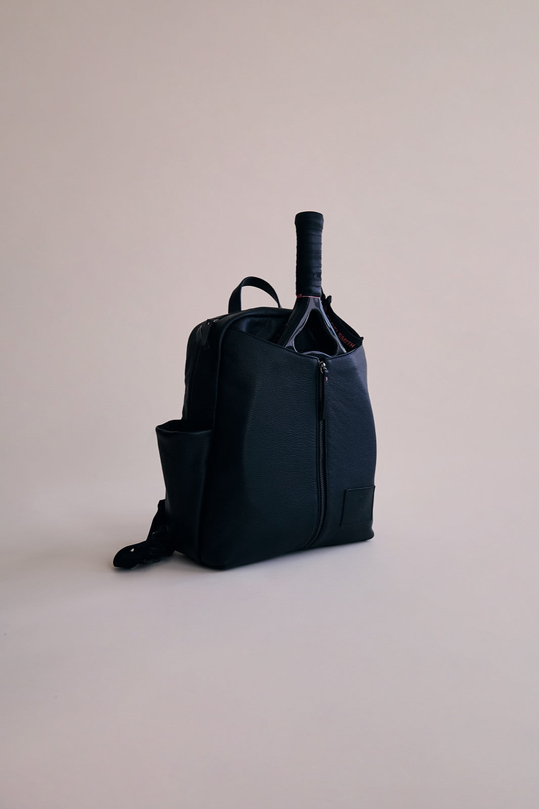 The Padelsmith Bag in the studio with a racket in the front pouch