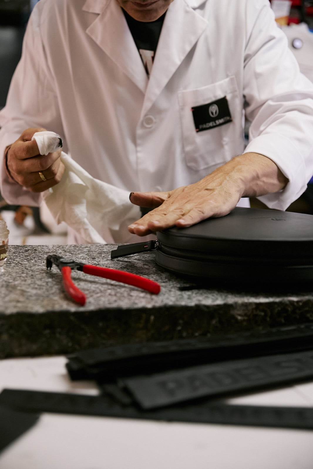 Smoothing the Plume leather of The Padelsmith Cover by hand