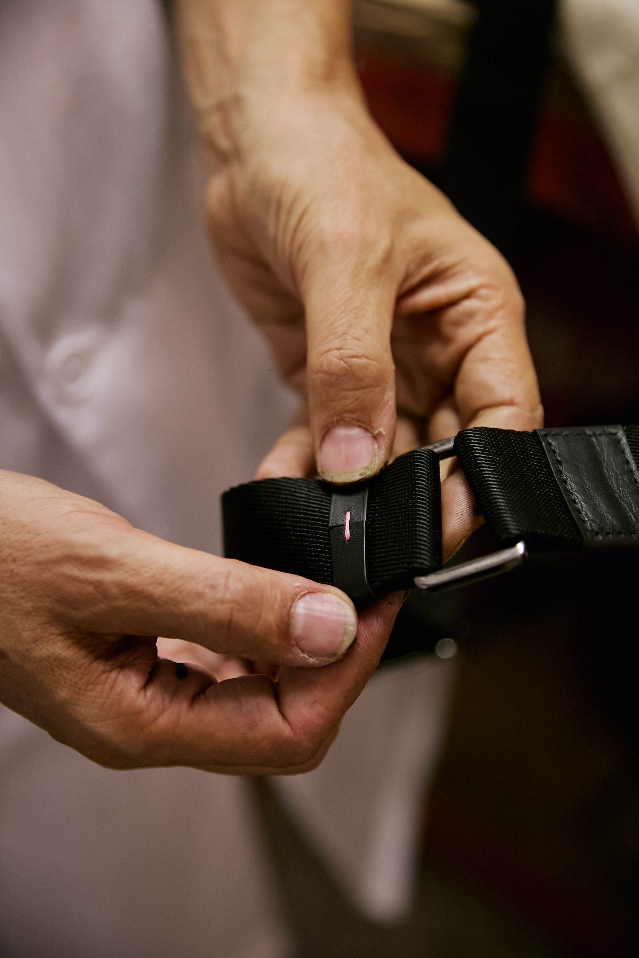 Adjusting the technical webbing strap and black hardware