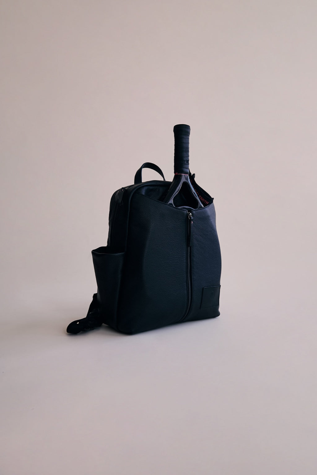 The Padelsmith Bag in the studio with a racket in the front pouch