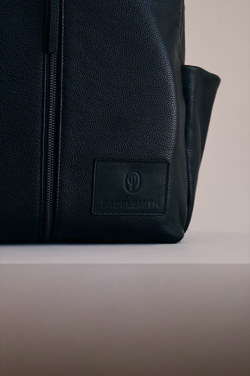 The debossed Padelsmith badge on the front of The Padelsmith Bag