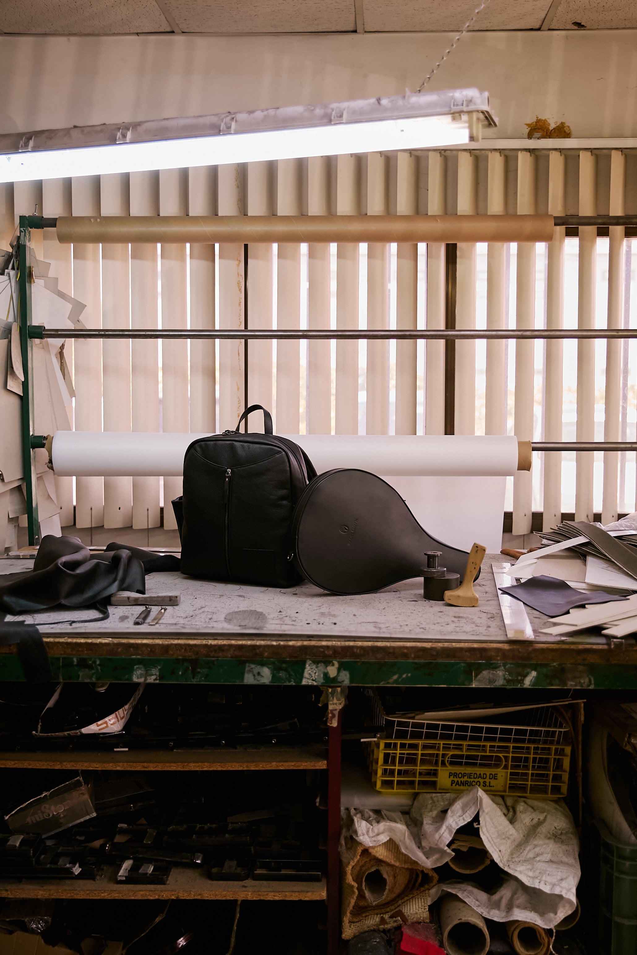 The Padelsmith Bag and The Padelsmith Cover on the workbench by the window