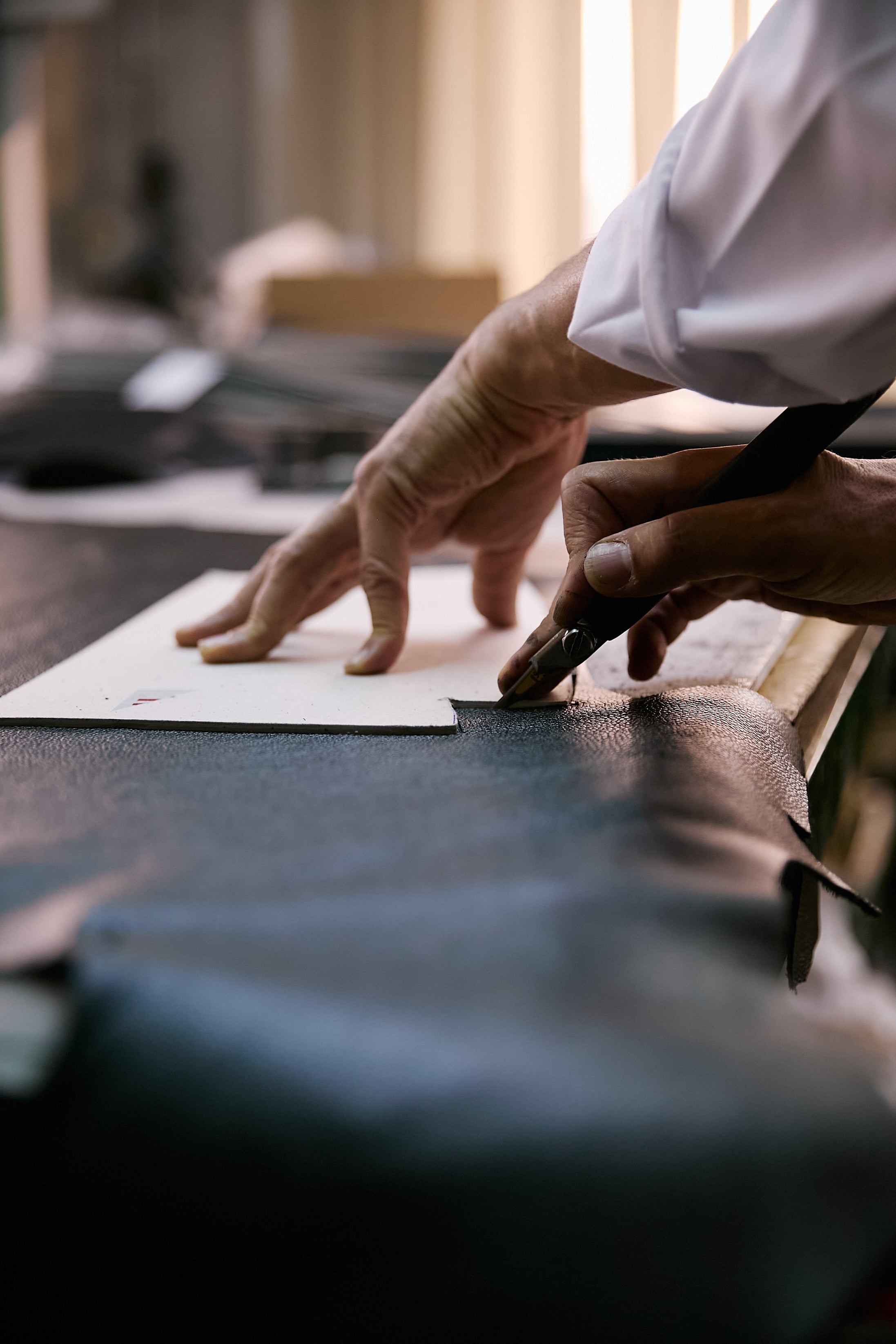 Cutting the Italian leather by hand against a template